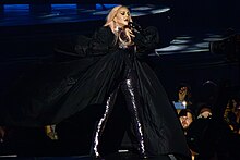 Madonna singing "Rain" during one of the concerts of the Celebration Tour (2023--2024) Madonna Celebration Tour (53334425364) (cropped).jpg