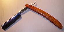 A straight razor with round point. Its high-gloss finish indicates metal plating usually associated with inferior quality. No name straight razor.JPG