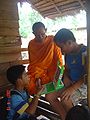 Students showing an XO to a local monk.