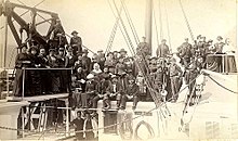 Passengers posing on upper deck of Olympian; walking beam can be seen on left. Olympian passengers on upper deck ca 1890.jpg