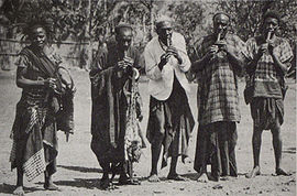 Lela celebrations in Bali, Cameroon, around 1908. Four men play on holy lela flutes. The celebrations are directed by members of the Bali royal family. Playing Lela flutes Cameroon.jpg