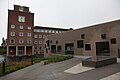 English: The new house for The Norwegian Meteorological Institute with the old building in the background. The house is mainly for the computing centre with canteen and meeting rooms above. The name of the house Tallhall means number hall.