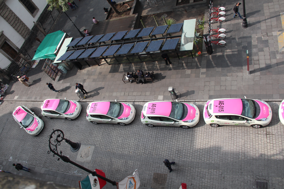 Electric taxis waiting to recharge, Zocalo, Mexico City]