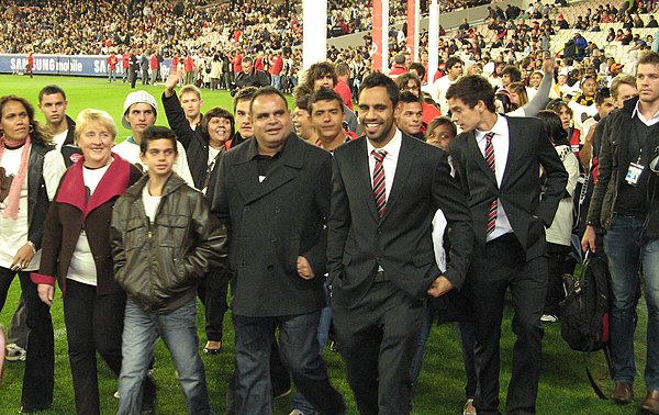 The Long Walk at the 2010 Dreamtime at the 'G match. Cathy Freeman (far left), Michael Long (centre-left) and Nathan Lovett-Murray (centre, in suit) a