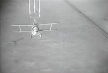 A Curtiss F9C-2 Sparrowhawk parasite fighter is released from the USS Akron airship. USS-Akron-parasite-figher-release.gif