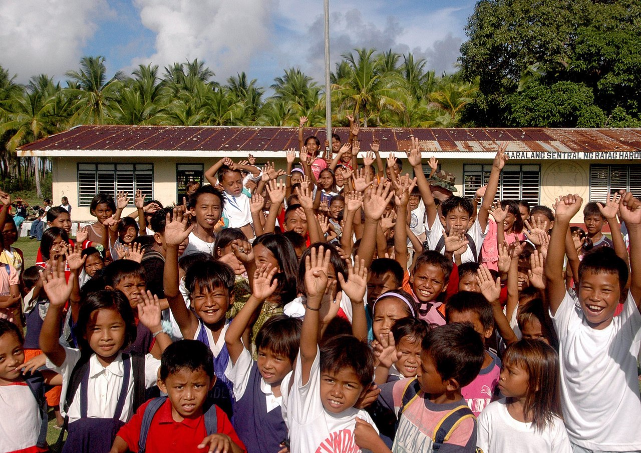 children waving goodbye at school