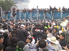 Protestors clash with Hong Kong police in the Wan Chai waterfront area during the WTO Ministerial Conference of 2005. WTO Ministerial Conference 2005 Protest.jpg