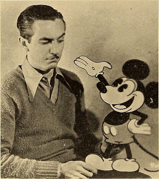 Walt Disney with a cutout of Mickey as he was drawn by the end of 1928
