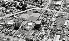 Clarence St gasworks in 1967 with Pembroke Rd, Pembroke La, Thackeray St, Tristram St in background - Hamilton, including city buildings. 1967 4 Apr Clarence St gasworks, Hamilton.jpg