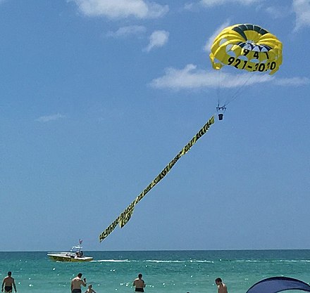 Banner towing by parasailing at Crescent Beach on Siesta Key