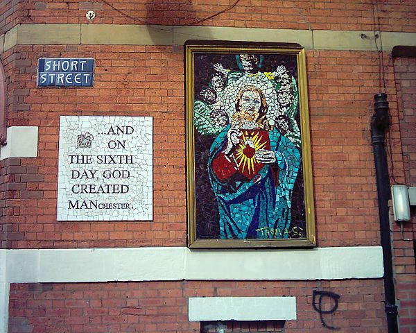 A mural on a wall outside Afflecks, in the heart of the Northern Quarter. The adjacent sign reads "...AND ON THE SIXTH DAY GOD CREATED MANCHESTER"
