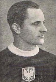 A black and white photo of a young man looking away from the camera and wearing a Polish national ice hockey team sweater