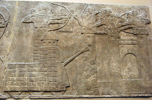 Assyrian attack on a town with archers and a wheeled battering ram; Neo-Assyrian relief, North-West Palace of Nimrud (room B, panel 18); 865–860 BC