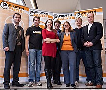 The Pirate Party leadership (2011). From left to right: Rene Brosig, Matthias Schrade, Marina Weisband, Sebastian Nerz, Gefion Thurmer, Wilm Schumacher, Bernd Schlomer BPT112 Offenbach-63.jpg