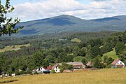 Čeština: Pohled na ves Libínské Sedlo a horu Bobík (1264 m n. m.), Jihočeský kraj. English: View of the Libínské Sedlo locality and Bobík mountain (1264 m above sea level), South Bohemian Region, Czechia.