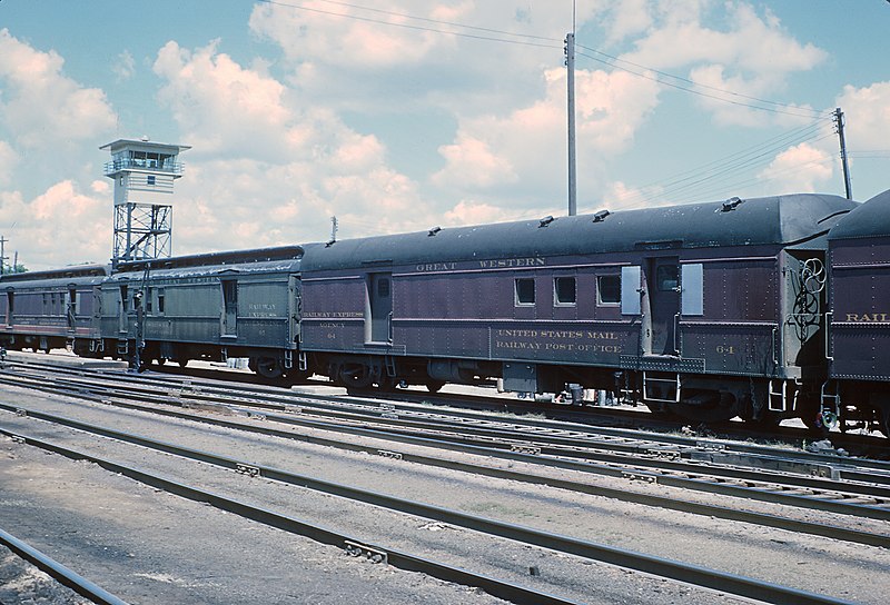 File:CGW 64 Baggage - RPO and Pullman Green RPO Baggage 67 in storage tracks at Olewein, Iowa. Yardmaster's Tower at upper left on August 7, 1962 (27493017972).jpg