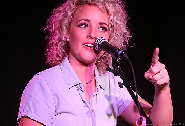 A blonde woman singing