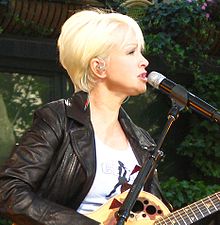 "Black Magic" was likened to Cyndi Lauper's "Girls Just Want to Have Fun" by several music critics for its "falling in love" refrain. Cyndi Lauper2 cropped.jpg