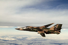 Military jet with swept wings in flight