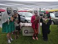 Four individuals in costume showing off books at ECM Pride 2018.jpg