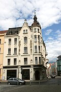 Residential and commercial building in closed development, corner house