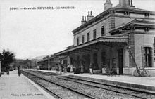 Het station in de vroege jaren 1900, met zijn twee sporen, twee platforms en het passagiersgebouw met een centraal lichaam met 5 openingen en 2 vleugels met één opening.  Op dit gebouw is een feesttent geplaatst