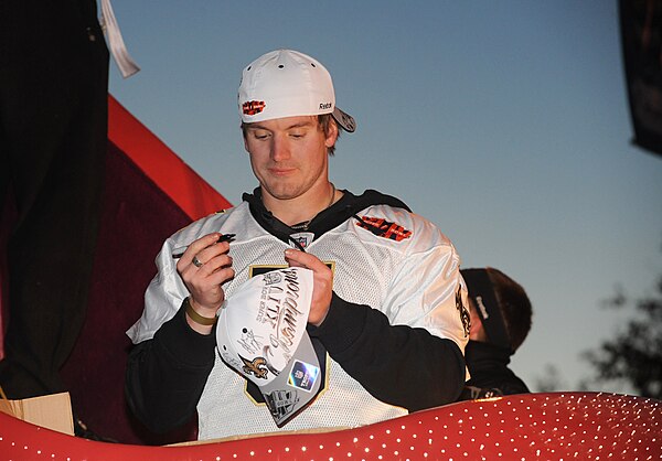 Hartley signs an autograph at the Saints Super Bowl parade in 2010