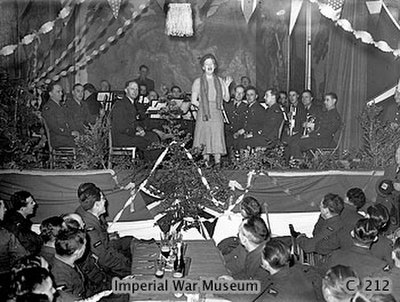 Fields, accompanied by an RAF orchestra, entertains airmen at their 1939 Christmas party