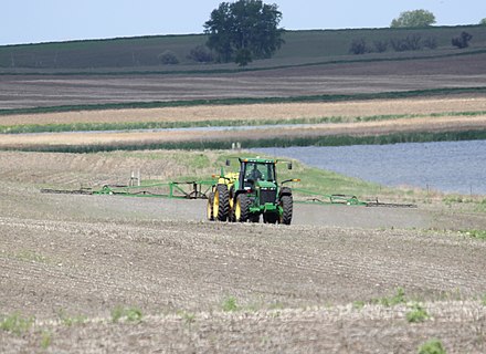 Herbicides being sprayed from the spray arms of a tractor in North Dakota.