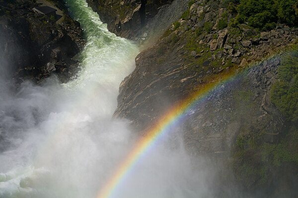 Rainbows are formed by dispersion of light, in which the refraction angle depends on the light's frequency.