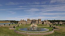 Holkham Hall, South front (1734) - the four flanking wings are elevated, in height and importance, almost to the status of the central block. Holkham-Hall-South-Facafe.jpg