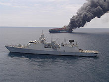 MV Hyundai Fortune on fire, with HNLMS De Zeven Provincien in the foreground, 2006. Hr Ms De Zeven Provincien helpt brandend containerschip2 tcm46-95807.jpg