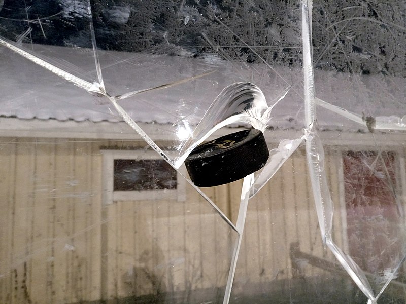 File:Ice hockey puck in broken plexiglass.jpg