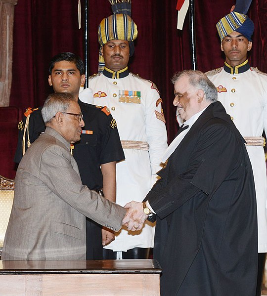 President Pranab Mukherjee greets the Chief Justice of India, Justice Sathasivam, after administering the oath of office to him, at a swearing-in cere