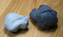 Two kneaded erasers. A new eraser is on the left, and an older eraser on the right. The older eraser is darker due to the graphite and charcoal dust that has become incorporated into it. Kneaded eraser.jpg