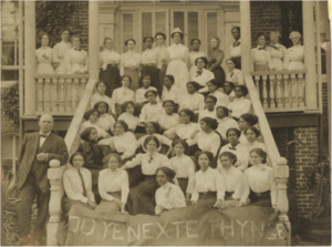 nursing students posing for a photo in front of their dorm.