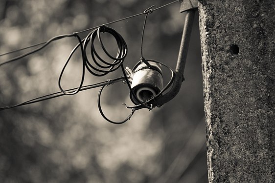 Black-and-white photo of old electric pole and wires in the country-side, Emen village, Bulgaria