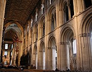 Peterborough Cathedral, the three-stage nave 1155-75 has piers of ovoid section with attached shafts. While the forms are typically Norman, the length is greater than found in Normandy. The wooden ceiling is original.