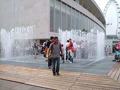 Walking through the Appearing Rooms fountain installation, by Danish artist Jeppe Hein, outside the RFH during reopening celebrations after 2007 refurbishment.