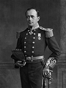 Man with receding hairline, looking left, wearing naval uniform with medals, polished buttons and heavy shoulder decorations