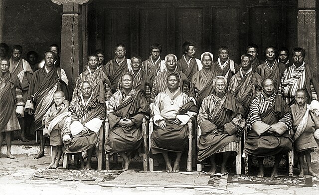 Ugyen Wangchuck surrounded by his councillors at Punakha, Bhutan, 1905. Front Row: son of Thimphu Jongpen, Punakha Jongpen, Thimphu Jongpen, Trongsa P
