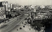 A large Japanese city with American soldiers patrolling the streets