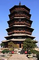 A wide, wooden pagoda. Despite having nine stories on the inside, it appears to have five, exceptionally tall stories from the outside. The ground floor and the second floor are separated by a double eave, and the other external stories are separated by single eaves. The bottommost eave is much wider than the others.