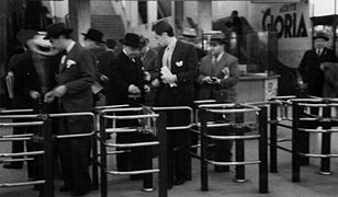 Passengers going through turnstiles on the line c.1934