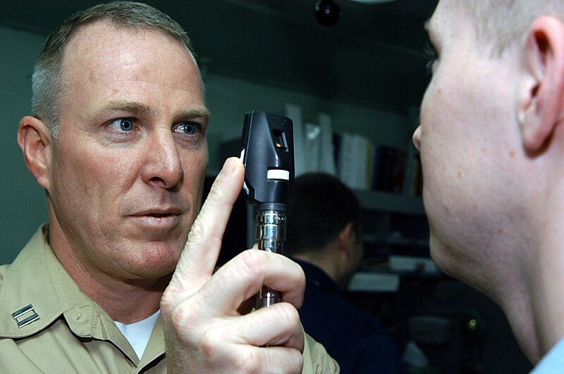 File:US Navy 040322-N-6278K-025 Lt. James Strafford, of Santa Barbra, Calif., examines a patient's eyes in the Medical Department aboard USS George Washington (CVN 73).jpg