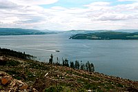 The inner firth seen from the Cowal peninsula near Dunoon, looking northeast to the coast of Inverclyde at Cloch point, south of Gourock and Greenock, and beyond that the Tail of the Bank. PS Waverley can be seen cruising south "doon the watter"