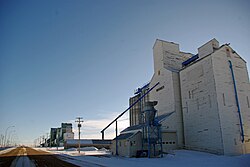 A grain elevator, for storing farmed grains typical on the Prairie Warner Elevator Row.jpg