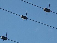 Wireless overhead power line sensors hanging from each of the three phases of a 4160 Volt powerline in a residential neighborhood, in Palo Alto, California WirelessPowerlineSensors3.jpg