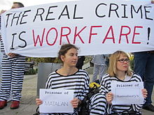 Activists dressed like to 19th century-prison inmates demonstrating against workfare, comparing it to 19th century-prison conditions with penal labour, October 2011. Workfare.jpg