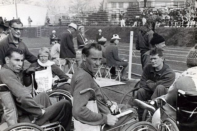 Australian Paralympic Team members in the in-field at the athletics during the 1964 Tokyo Paralympic Games. From left (seated) Frank Ponta, team offic